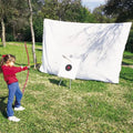 White archery netting with a target and a girl practicing archery.