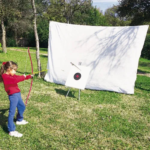 White archery netting with a target and a girl practicing archery.