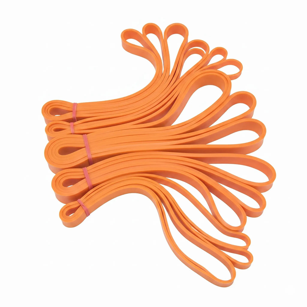 Orange resistance loop bands in various sizes, fanned out on a white background.
