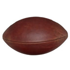 A brown, textured Spalding Alpha football shown from a side profile angle against a white background.