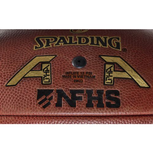 Close-up of a brown Spalding Alpha football featuring gold logos, black NFHS branding, and inflation instructions.