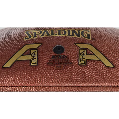 Close-up of a brown leather Spalding Alpha football featuring gold logos and inflation instructions.