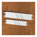 Two white rectangular pitcher's rubbers with attached metal spikes, shown from a top-down angle on a dirt surface.