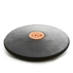 A black rubber Nelco discus with a central copper-colored plate marked "1.61K," shown from a low-angle perspective.