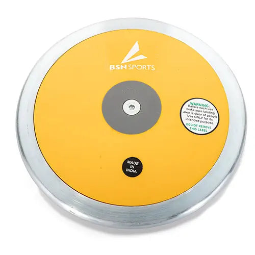 A top-down view of a BSN Sports Gold Lo-Spin discus featuring a yellow face, silver rim, and central metal plate.